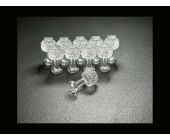 Dent Lab Hail Stone 9mm clear PDR glue tabs, 10-pack on black surface with one tab on its side.