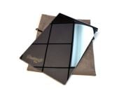 Mirror finish stainless window shield with 1.5-inch flange, resting on its gray carry pouch, on a white background.